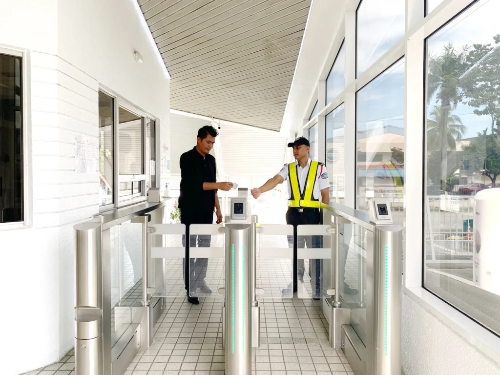 Biometric access control for hospital entrance with SECOM Malaysia guard assisting authorised entry