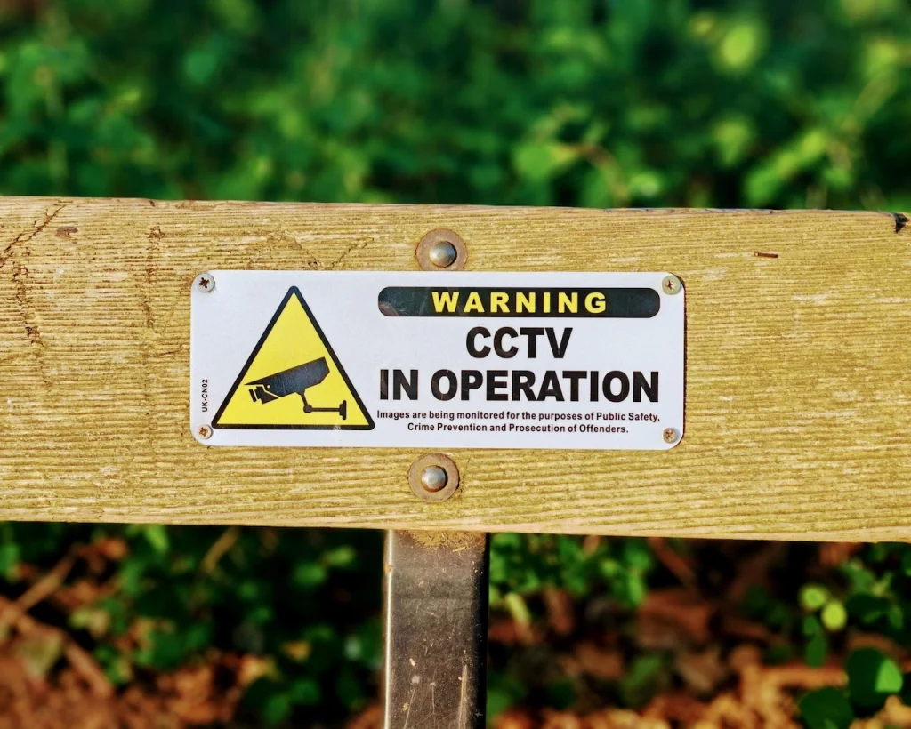 Visible CCTV warning sign informing visitors of active surveillance for safety and monitoring purposes.