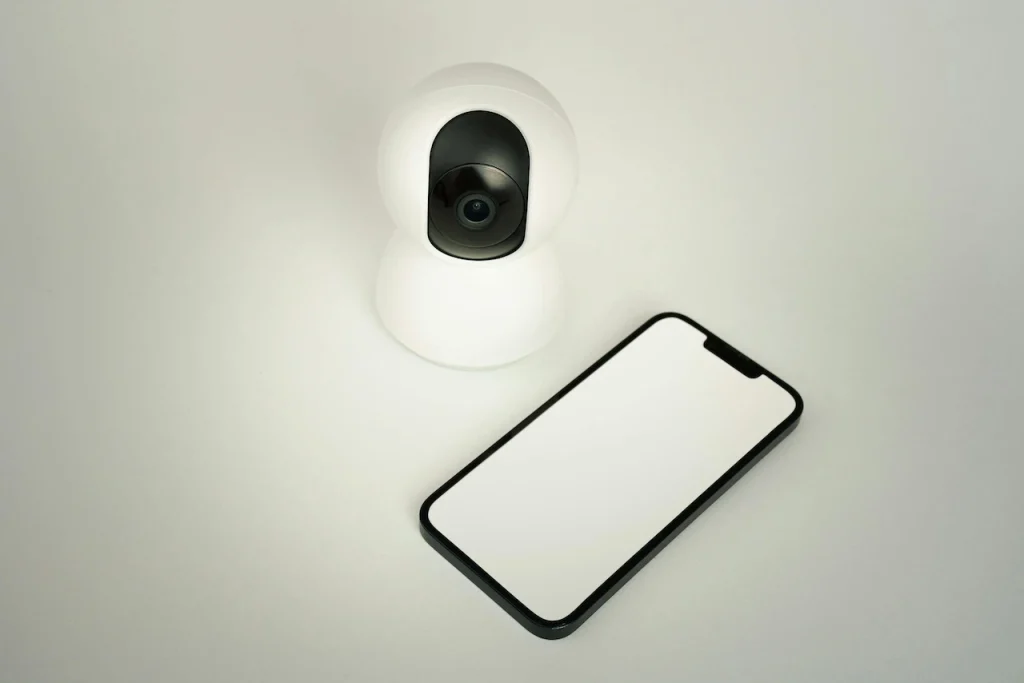 Smart wireless security camera and smartphone representing flexible remote monitoring solutions