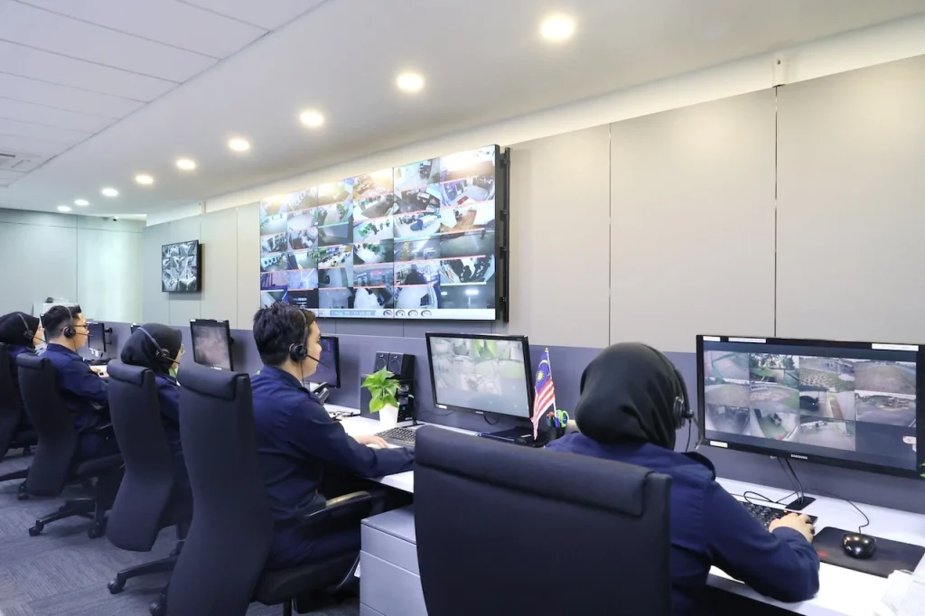 Security operators using remote monitoring and CCTV surveillance to watch multiple sites from a control room