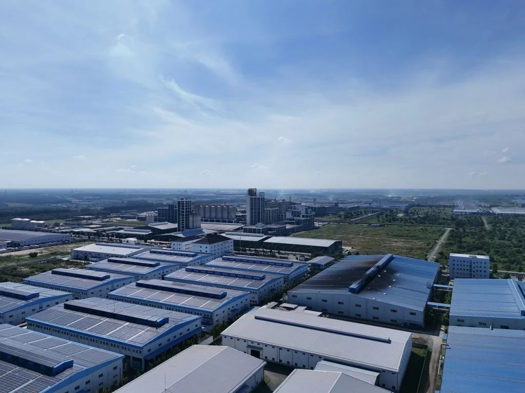 Aerial view of an industrial park with factory rooftops suited to a real time factory monitoring system