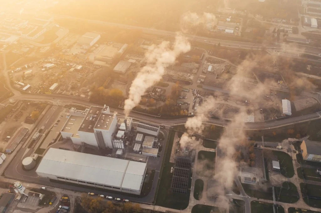 Aerial view of an industrial facility with smokestacks, illustrating the need for industrial security monitoring