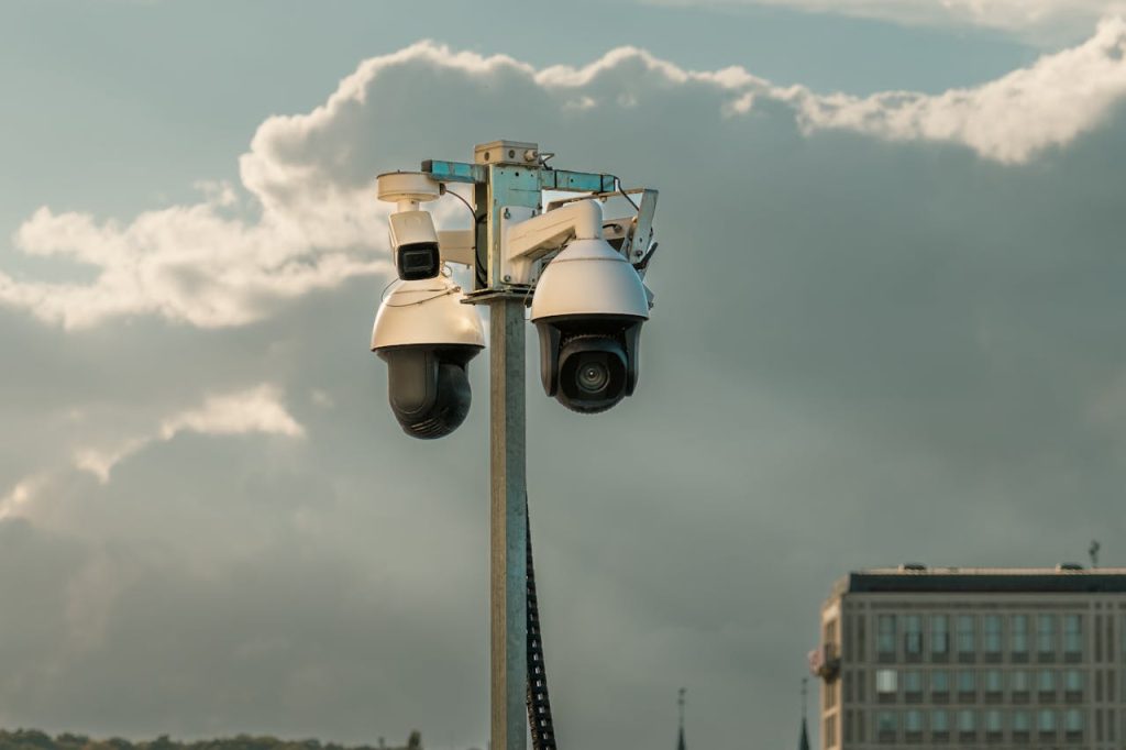 Close-up of multiple CCTV security cameras installed outdoors, representing advanced surveillance in remote monitoring systems for commercial properties.