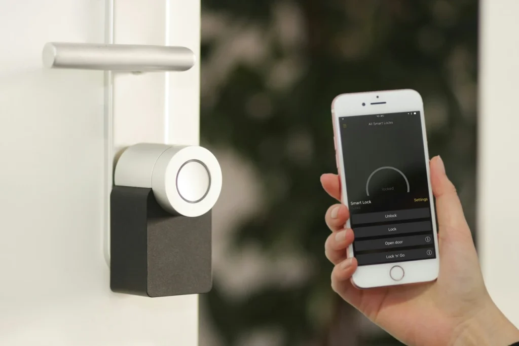 Smart wireless door lock controlled via mobile app, illustrating a wireless alarm system setup in a modern building.