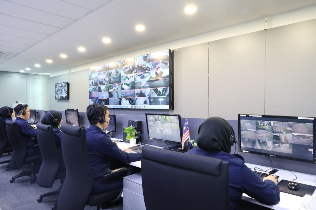 SECOM Malaysia central monitoring centre operators managing multi-site CCTV and alarm events from integrated security dashboards in Malaysia.